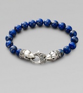 A welcome touch of color, strung with 10mm lapis beads and a raven's head sterling silver clasp.About 9¼ long Imported