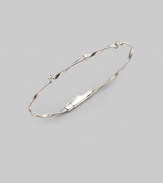 Simply stunning, this 18k gold bangle with delicate ridges and twists is studded with glimmering diamonds. Diamonds, 0.15 tcw 18k gold Diameter, about 2½ Push-lock clasp Made in Italy Please note: Bracelets sold separately.