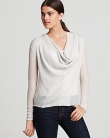 A draped cowlneck lends effortless elegance to a Helmut Lang sweater embellished with seam detail and featuring a high/low hem. Teamed with dark-wash denim, the day-ready look is perfect for the park.