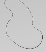 A simple oxidized sterling silver chain with a 14k gold cross, attached sideways for a modern look. 14k goldOxidized sterling silverLength, about 26Slip-on style Made in USA 