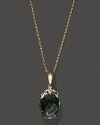 Diamonds accent a faceted green amethyst, set in 14K yellow gold.