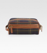 A signature tartan plaid design appoints this fine canvas toiletry bag with heritage appeal. Leather trim Side handle Zip closure 9W X 6¼H X 5½D Imported 