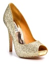 Add some glamour to a simple dress. Goldtone glitter peeptoe pumps with a tall covered heel and platform.