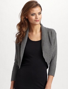 Wide shawl collar knit in ultra soft silk/cashmere. Ribbed collar, cuffs and hem Cropped sleeves About 16 from shoulder to hem 85% silk/15% cashmere; dry clean Imported Wide shawl collar knit in ultra soft silk/cashmere. Ribbed collar, cuffs and hem Cropped sleeves About 16 from shoulder to hem 85% silk/15% cashmere; dry clean Imported
