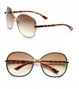 Sleek, shiny metal frames in a modern, round shape. Available in shiny light bronze with brown gradient lens. 100% UV protectionMade in Italy 