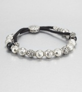 From the Batu Pelu Collection. Beads of black tourmaline join with carved and faceted beads of sterling silver in this eye-catching strand, strung on a black cord with a bold slide closure.Black tourmalineSterling silverAdjusts from about 6 to 9 longSliding bead closureMade in Bali