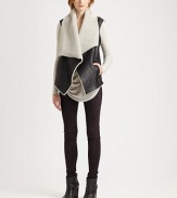 An oversized layering piece crafted of textured leather lined with ultra-soft shearling. Asymmetrical neckline with shearling trimSleevelessFront clasp closureFront slash pocketsAbout 30½ from shoulder to hemBody: LambskinLining: Genuine lamb shearlingDry clean with fur specialistImported of Italian fabricFur origin: ChinaModel shown is 5'10 (177cm) wearing US size Small.