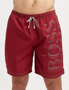 Hit the beach in authentic style in a solid pair with contrast stitching and large logo detail.Elastic drawstring waistSide slash, back patch pocketsInseam, about 755% polyamide/45% polyesterMachine washImported Hit the beach in authentic style in a solid pair with contrast stitching and large logo detail.Elastic drawstring waistSide slash, back patch pocketsInseam, about 755% polyamide/45% polyesterMachine washImported