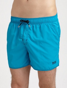 Stylish swim trunks are both sporty and functional, rendered in quick-drying nylon.Elastic drawstring waistSide slash, back flap pocketsInseam, about 4PolyamideMachine washImported Stylish swim trunks are both sporty and functional, rendered in quick-drying nylon.Elastic drawstring waistSide slash, back flap pocketsInseam, about 4PolyamideMachine washImported