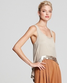 The glistening sequin high/low hem on this Robert Rodriguez silk tank creates a striking silhouette and a slimming effect over pants and skirts alike.