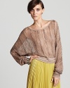 Rendered in a loose knit weave with dolman sleeves, this BCBGMAXAZRIA sweater is cropped for new-season cool and smart with a lighthearted ladylike pleated skirt.