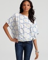 An oceanic geometric-print lends tranquility to this silk DIANE von FURSRENBERG top, a luxurious pairing for off-duty denim. For workdays and weekends alike, the piece is best accented with an armful of silver bangles for a touch of shimmering glam.