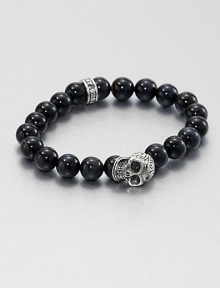 A striking skull pendant of sterling silver accents a stretch beaded bracelet of blue tigers' eye for the modern man of style.Sterling silverTigers' eyeWidth, about 10mmDiameter, about 3Made in USA A striking skull pendant of sterling silver accents a stretch beaded bracelet of blue tigers' eye for the modern man of style.Sterling silverTigers' eyeWidth, about 10mmDiameter, about 3Made in USA