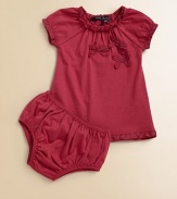 A frilly, girlie set with lace trim, bows and matching bloomers is perfect for any occasion.Crewneck with lace trimShort cap sleeves with lace trimPullover styleGathered bodiceA-line silhouetteMatching bloomers have elastic waistband and leg openingsCottonMachine washImported