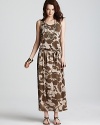 Camouflage goes chic as this MICHAEL Michael Kors maxi dress plays up a natural color palette with an oversized floral print. Garnish with gold accents for 24-7 style.