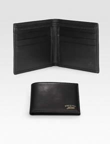 Leather bi-fold wallet accented with Made in Italy by Gucci script gold engraving. Two bill compartmentsSix card slotsClosed: 4.3W x 3.5H x .6DOpen: 8.4W x 3.5HMade in Italy Leather bi-fold wallet accented with Made in Italy by Gucci script gold engraving. Two bill compartmentsSix card slotsClosed: 4.3W x 3.5H x .6DOpen: 8.4W x 3.5HMade in Italy