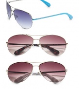 Classic metal aviator style with signature logo on plastic colored temples. Available in turquoise with blue gradient lens, tortoise with brown gradient lens, white with brown gradient lens, red with brown gradient lens, blue/silver with grey lens or ivory/copper with brown gradient lens. 100% UV protection Imported