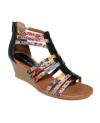 Packed schedule? Keep it cute as you get it all done. Madden Girl's Bizzy sandals feature colorful fabric straps, a trendy back zipper and a contrasting walkable wedge.