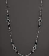 Faceted black onyx blooms along an intricate sterling silver chain. By Konstantino.