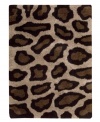 Exotic designs will be the pride of your decor. Adorned with leopard spots in beige and black, this Nourison rug has a marvelously soft and shaggy pile that's hand-tufted from premium-quality yarns. Beautiful in appearance and plush underfoot, this area rug creates an atmosphere of casual elegance. (Clearance)