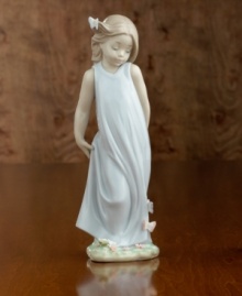 A little girl in a flowing gown crowned with a butterlfy in her hair and on her dress. Porcelain. Measures 8.5 x 3.25. A little girl in a flowing gown crowned with a butterlfy in her hair and on her dress. Porcelain. Measures 8.5 x 3.25.