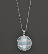 A faceted doublet of Swiss blue topaz and white sapphire, set in sterling silver, forms an elegant Maltese cross. By Elizabeth Showers.
