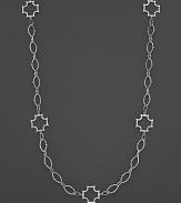 Sterling silver Maltese crosses punctuate a long chain. By Elizabeth Showers.