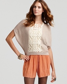 A lightweight metallic Free People top flaunts short dolman sleeves and a sheer lace panel through the front for the perfect juxtaposition of modernity and romance. Partnered with potent-hued shorts, the lively look is a holiday hit!