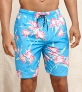 Get inspired for summer with these tropical print swim trunks from Tommy Hilfiger.