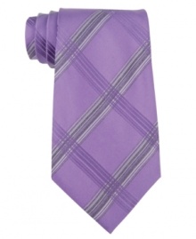 A big bold plaid tie from Calvin Klein makes an instant statement in your dress wardrobe. A big bold plaid tie from Calvin Klein makes an instant statement in your dress wardrobe.