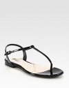 A minimalist t-strap silhouette crafted in Italy of luxurious patent leather. Patent leather upperAdjustable ankle strapLeather lining and solePadded insoleMade in Italy