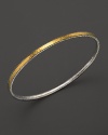Sterling silver frames a bright band of 24K. gold--elegant alone, luxe when stacked. By Gurhan.