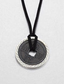 From the Classic Chain Collection. The center of this striking pendant has the look of an ancient coin with its square hole and blackened finish, set in a distinctive carved setting of polished sterling silver and hanging from a black cord.Sterling silverBlack fabric cordCord length, about 22 to 24 (adjustable)Pendant diameter, about 1.75Lobster claspMade in Bali From the Classic Chain Collection. The center of this striking pendant has the look of an ancient coin with its square hole and blackened finish, set in a distinctive carved setting of polished sterling silver and hanging from a black cord.Sterling silverBlack fabric cordCord length, about 22 to 24 (adjustable)Pendant diameter, about 1.75Lobster claspMade in Bali
