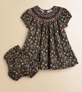 Tailored in airy cotton for a gently flowing silhouette, a darling short-sleeved floral-print dress is beautifully complemented with a smocked neckline and embroidery. Round smocked necklineShort puffed sleevesBack buttonsFull skirtRuffled hemCottonHand washImported Please note: Number of buttons may vary depending on size ordered. 