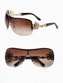 From the Mediterranean Flower Collection. These limited edition frames feature a gentle shield shape with brilliant, crystal accented flower temples. Available in silver/black with grey gradient lens or pale gold/dark brown with brown gradient lens. Crystal accented, flower logo temples100% UV protectionMade in Italy From the Mediterranean Flower Collection. These limited edition frames feature a gentle shield shape with brilliant, crystal accented flower temples. Available in silver/black with grey gradient lens or pale gold/dark brown with brown gradient lens. Crystal accented, flower logo temples100% UV protectionMade in Italy