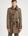 Featuring clever details and classic tailoring, a belted trenchcoat made from virgin wool.Notched collarGunflapButton closureBack yokeRainflapBack ventsAbout 35 from shoulder to hemVirgin woolDry cleanImported of Italian fabric