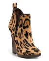 Be queen of the urban jungle in these towering wedge booties, wrapped with decadent leopard print haircalf--a striking pairing with fall's jewel tones. By Pelle Moda.