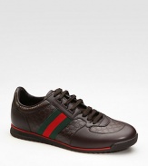 Lace-up sneaker in micro guccissima and smooth leathers with signature green/red/green web. Rubber sole Made in Italy 