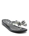 Preppy gingham lends a cheerful touch to these casual yet oh-so-ladylike flip flops from GUESS.