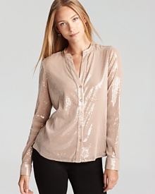 Demure yet dramatic, this Calvin Klein blouse shimmers with a subtle sequin finish for a 24-7 standout look. Team with jeans for a luxe approach to laidback style, or slip the statement piece over trousers for workweek chic.