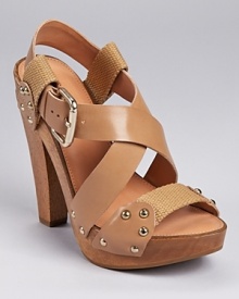 Canvas trim grounds a luxe leather look from Madison Harding. A wooden sole lends a clog-like feel. Canvas trim grounds a luxe leather look from Madison Harding. A wooden sole lends a clog-like feel.