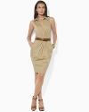 The shirt dress is reinvented in a feminine silhouette with a crossover V-neckline and elegant pleated skirt.