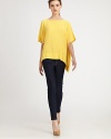 An easy way to achieve that relaxed, contemporary aesthetic, this woven silk top has dropped shoulders and an asymmetrical hem. BoatneckDropped shouldersShort dolman sleevesAsymmetrical cropped front hemViscose/rayonDry cleanImportedSIZE & FITModel shown is 5'10 (177cm) wearing US size X-Small/Small. 