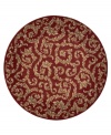 Evoking the opulence of European decor, this round rug features an elegant floral scroll pattern in gold against a rich russet ground, subtly framed in burgundy. The premium wool weave imparts rich texture and indulgent softness.