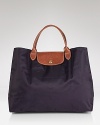 A timeless and durable nod to French style, this Longchamp nylon tote perfects daily errand-running for the très chic girl about town.