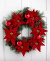 Welcome guests to your home with a wreath of bright red poinsettia and pine. Brilliant red ornaments add to the festive display, accenting a window or door with everlasting cheer.