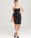 A strapless MARC BY MARC JACOBS dress flaunts a dramatic ruffle and color block lining for a playful party look teeming with trend-right style. Complete with chic by choosing black stilettos and a glossy sleek clutch.