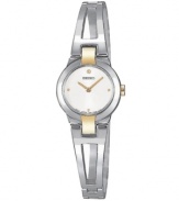The classic two-tone bracelet watch features a modern minimalist design. Round white dial, quartz movement. Water resistant up to 30 meters. 20mm.