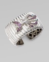 A substantial textural cuff adorned with a bird encrusted in amethyst, rhodolite and Swiss blue topaz. Sterling silver Amethyst Rhodolite Swiss blue topaz Kick mechanism closure Diameter, about 2½ Width, about 1½ Imported 