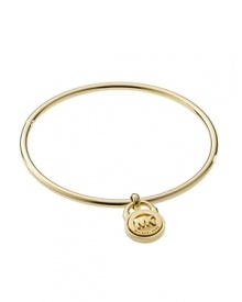 Give into logo lust with MICHAEL Michael Kors' delicate gold bangle. Do like the style pack and add this understated band to an armload of mix-and-match styles.